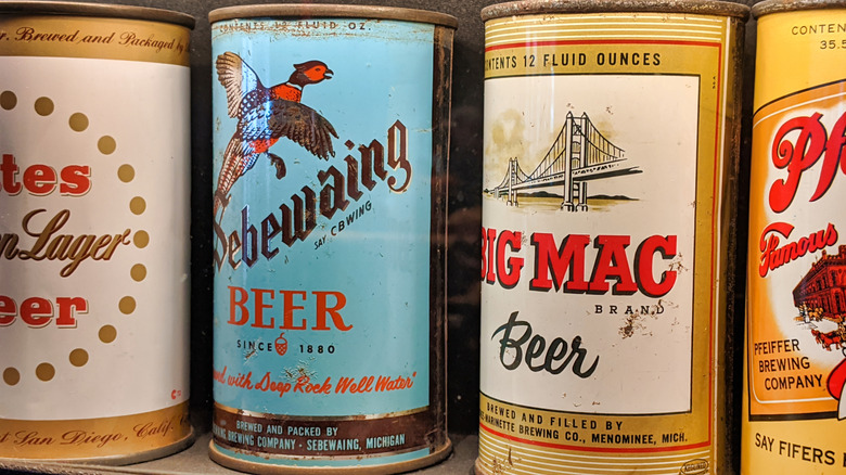 Closeup on four old local beer cans, including Michigan-based Big Mac Beer.