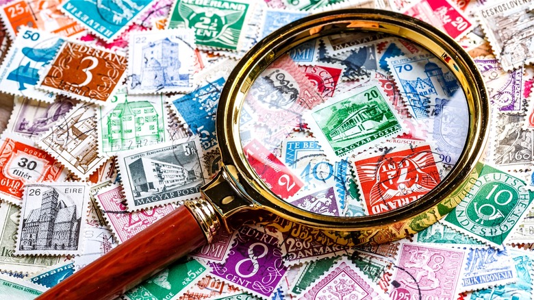 Magnifying glass rests on stamps