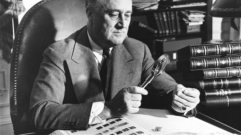 FDR examines stamp