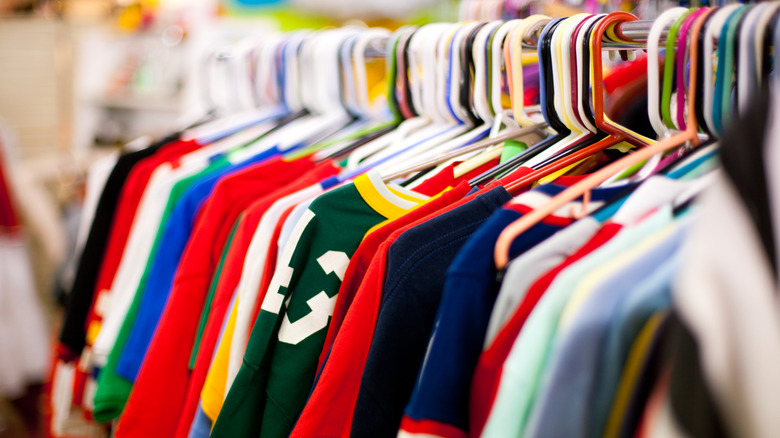 A clothing rack filled with vintage t-shirts.