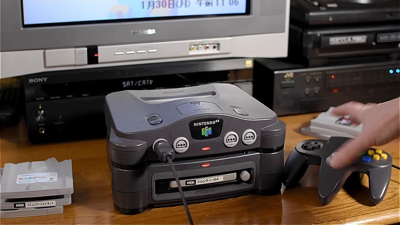 Hand grabs Nintendo 64DD controller