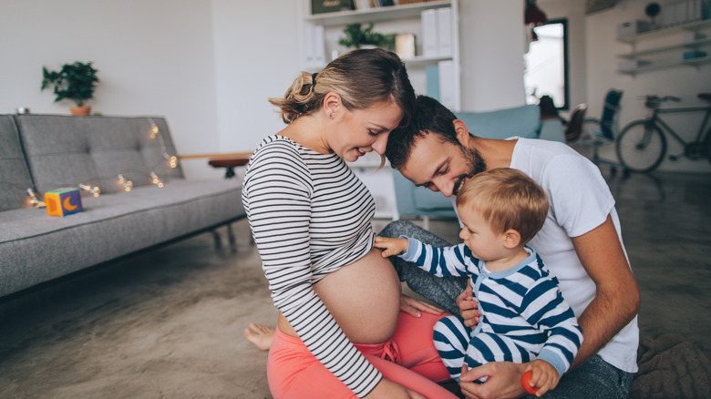 Little boy being curious about his mother's growing belly