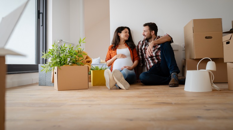 Couple expecting a baby just moved into an empty apartment,