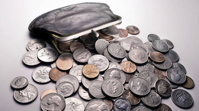 A coin purse spilling out different U.S. coins