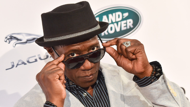 Actor Wesley Snipes wearing a bowler hat and sun glasses