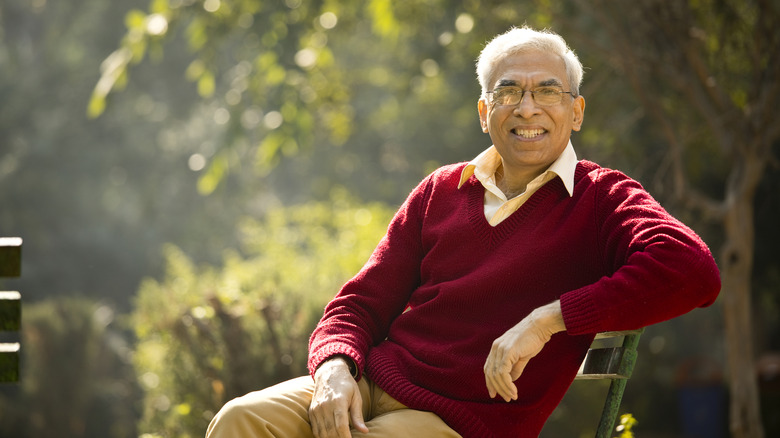 a retired man sitting on park bench