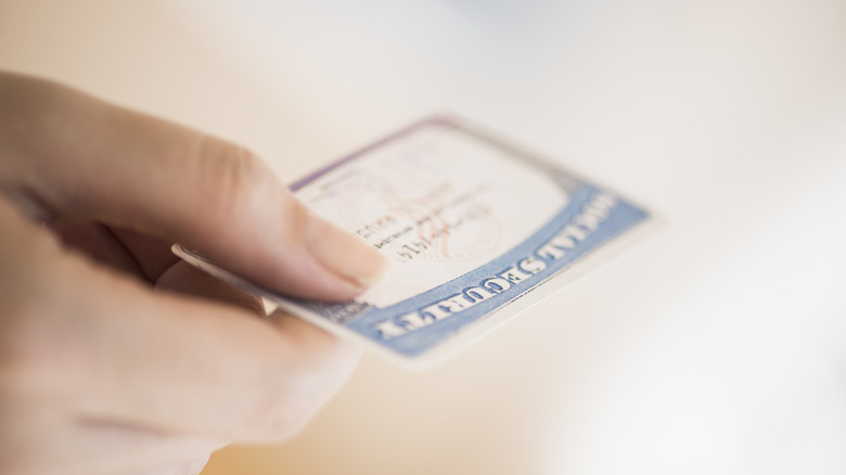 hand holding a social security card