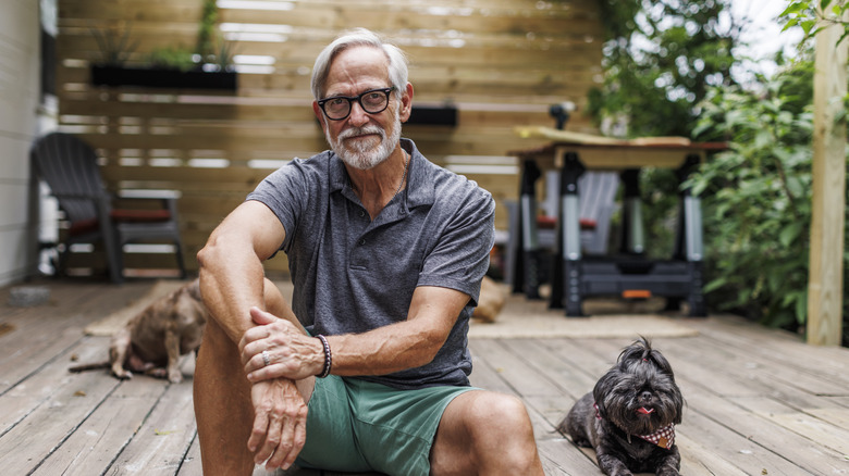 a senior man sitting on porch