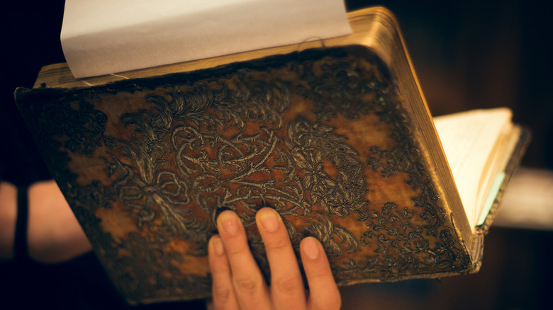 Hand holds antique book