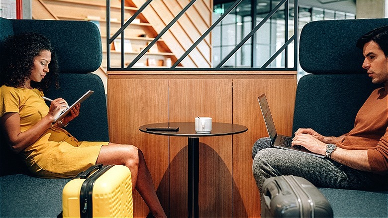 Two people in airport lounge