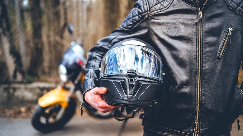 Person holding motorcycle helmet