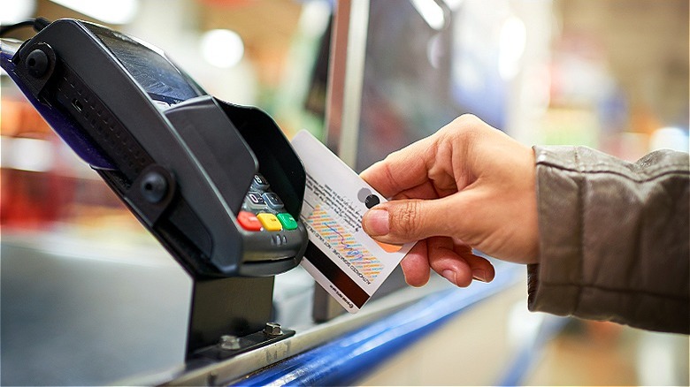 Person swiping credit card terminal