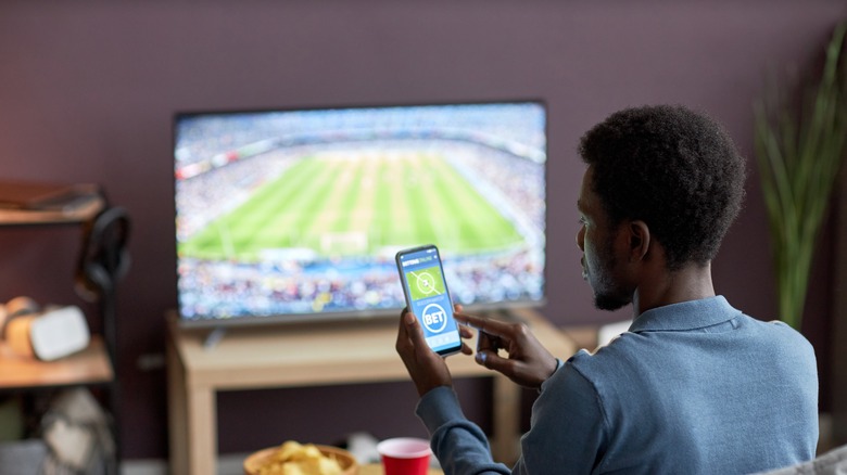 man betting while watching a game