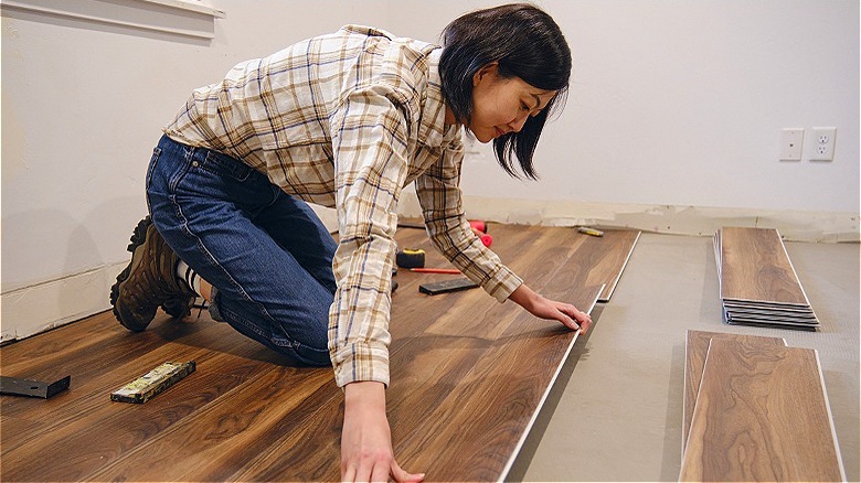 Person installing laminate floor planks