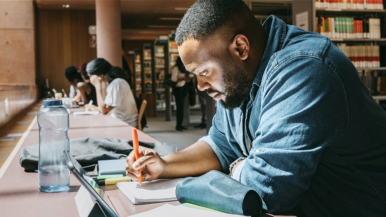 Graduate student studying in library