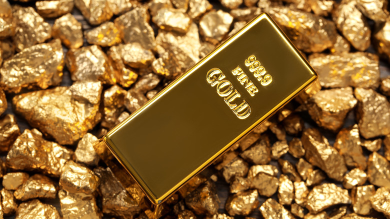 Gold bar rests on gold nuggets