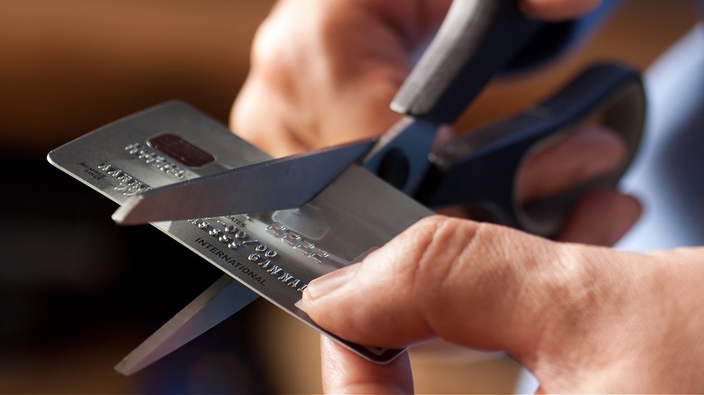 Person cutting up credit card