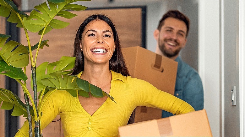 Two people smiling, moving in