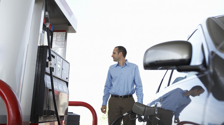 Man standing at gas station