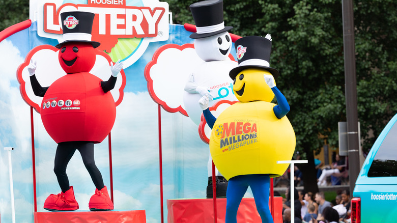 People dressed up as Hoosier Lottery Powerballs frolic on a flatbed truck.