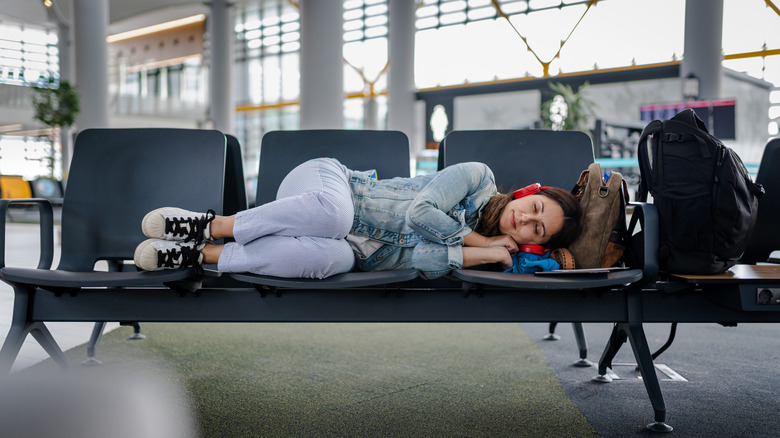 Airline passenger sleeping in airport