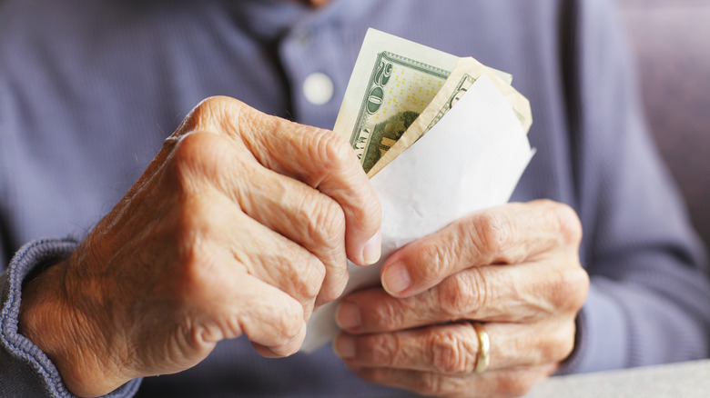 Older person holding cash