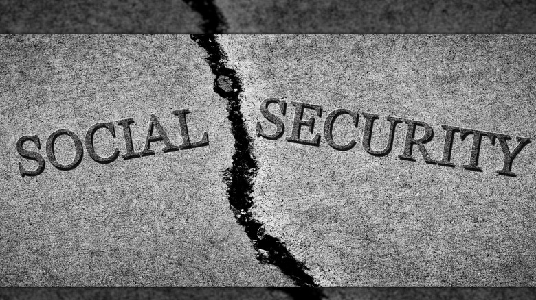 Social Security written on cracked sidewalk