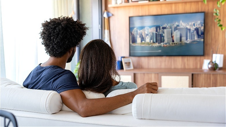 Couple watching television together