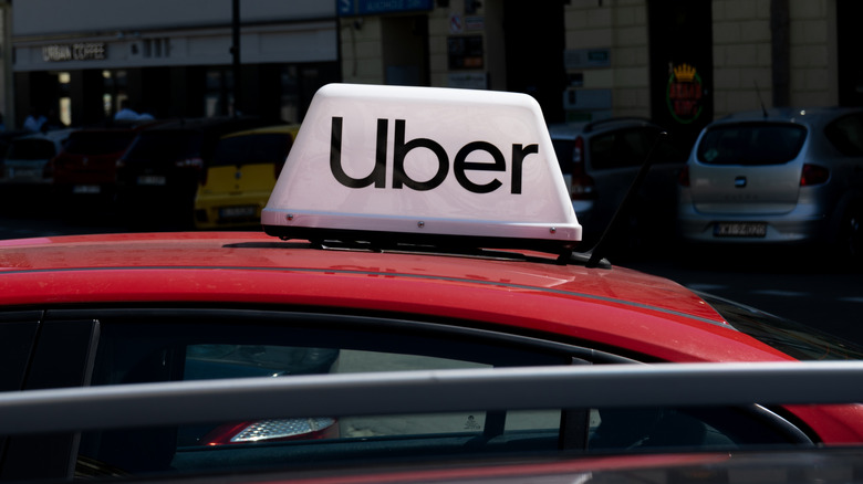 Uber logo sign on top of vehicle