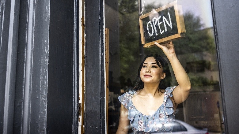 Small business owner opening store