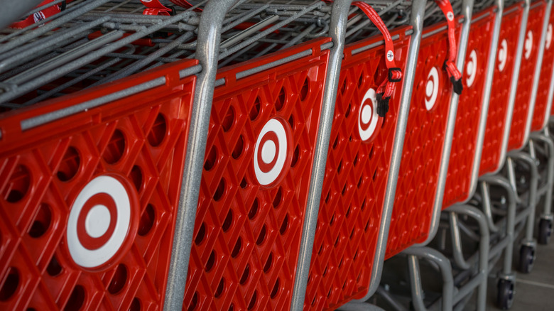 Close-up on a long row of cheery, red Target shopping carts emblazoned with the Target bullseye logo.