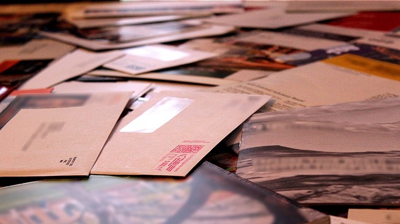 Mail envelopes piled on table