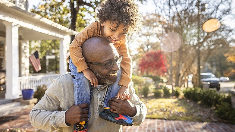 Man and child smiling outside