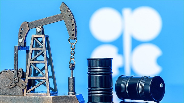 OPEC flag behind refinery equipment