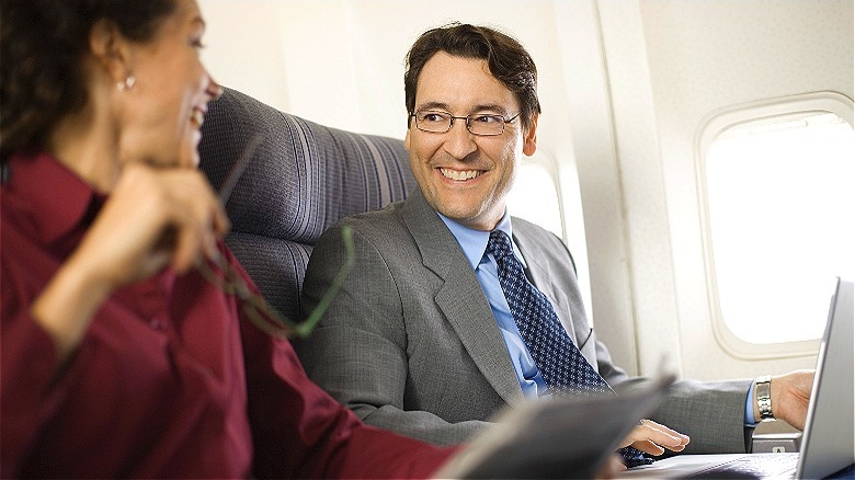 Business people talking on flight