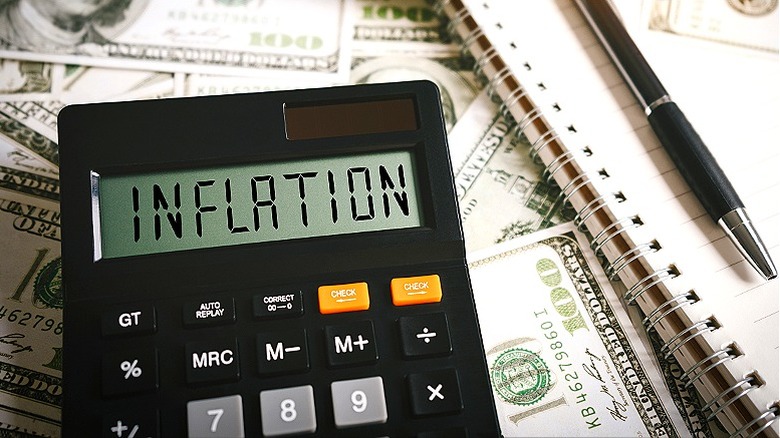 Money with calculator showing "INFLATION"