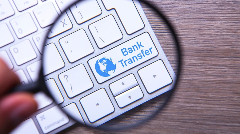 Magnifying glass over "Bank Transfer"