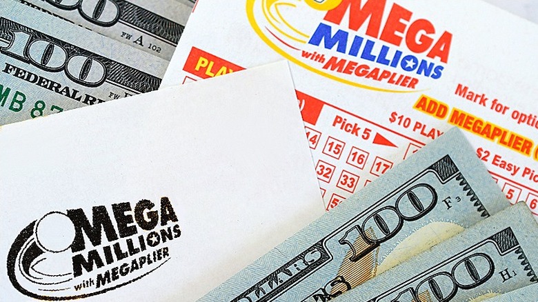 Mega Millions tickets surrounded by $100 bills