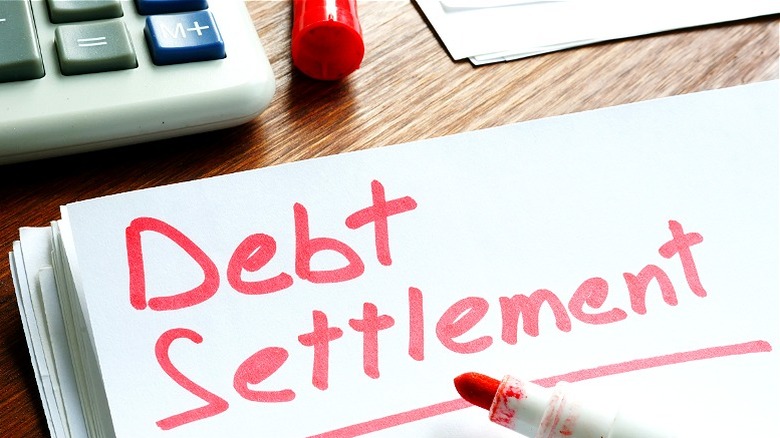 Debt settlement written on paper