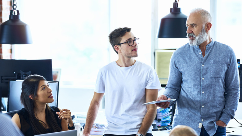 Team of creative people having meeting modern office