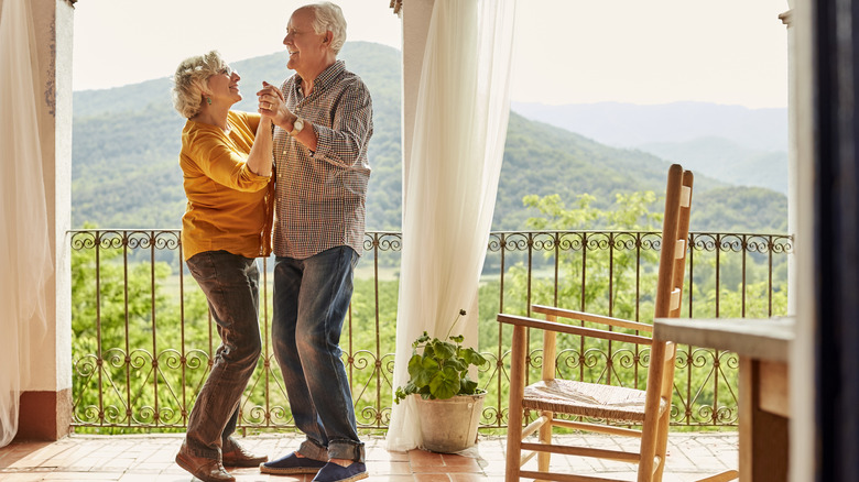 Retirees at home dancing on patio