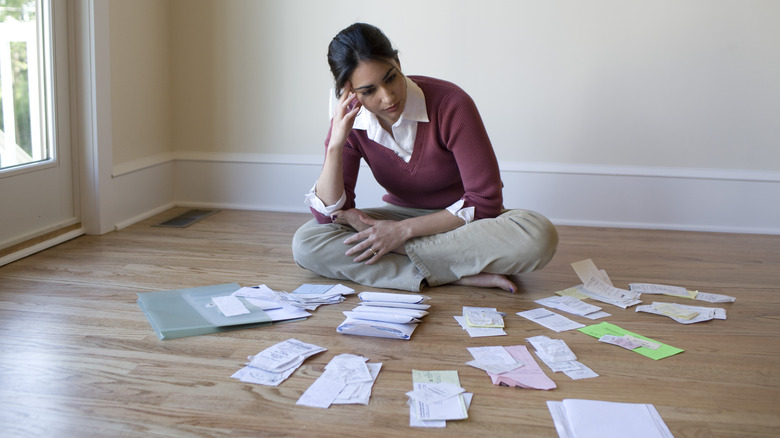 Woman looking at receipts while budgeting