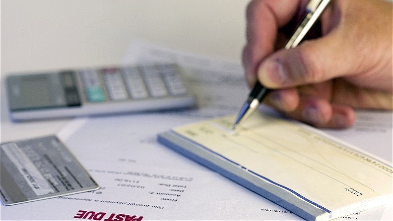 Person writing a bank check 