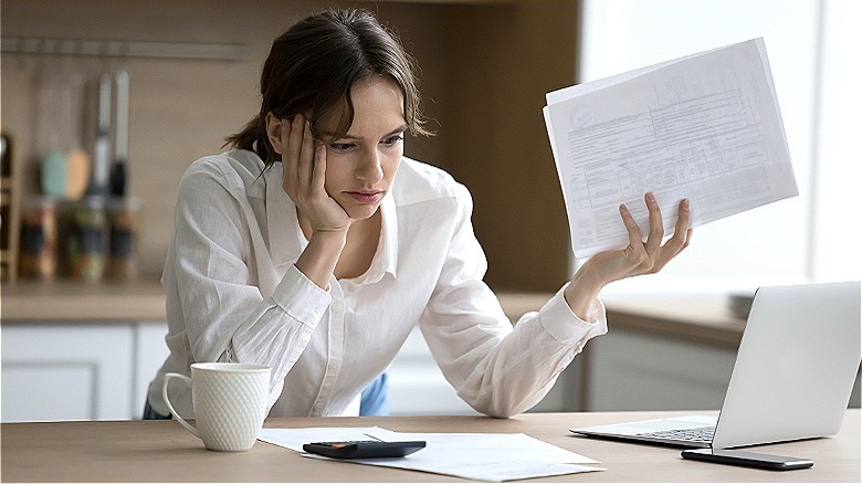 Person stressed over paperwork