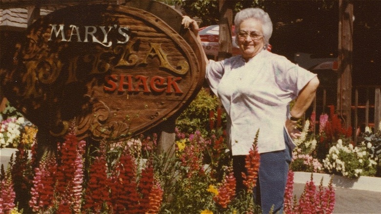 Mary Fazio next to Mary's Pizza Shack sign