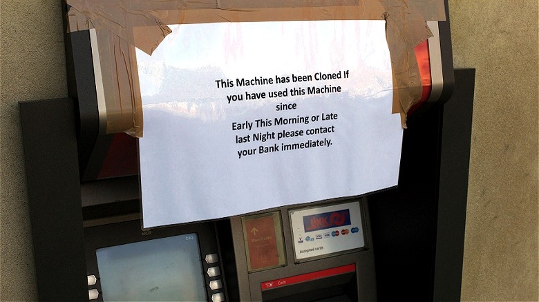 Fraudulent ATM machine with warning