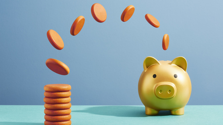 coins flipping into piggy bank