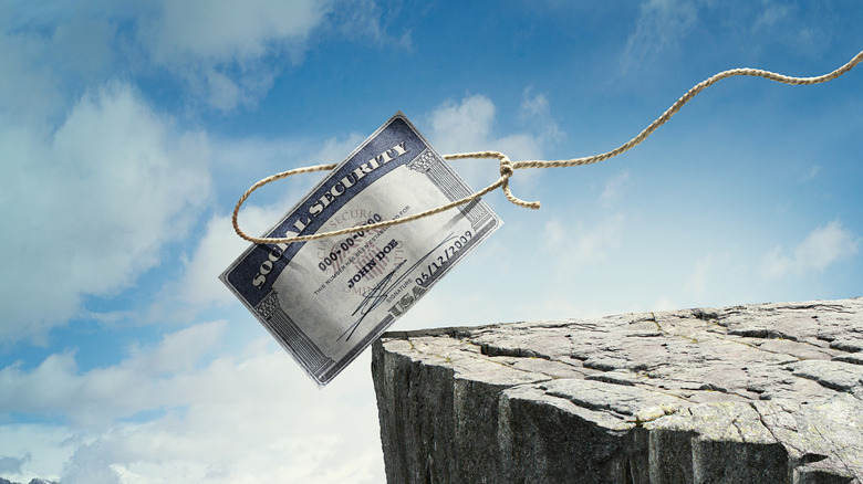 Social security check being roped at the edge of a cliff