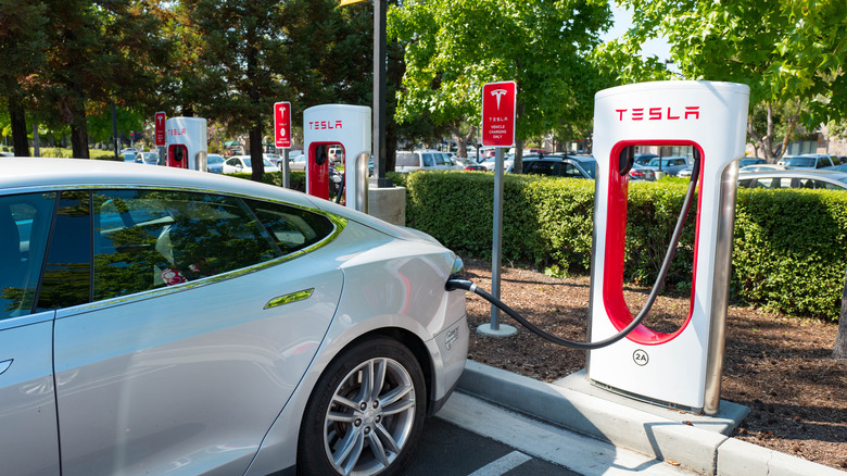 A Tesla charging at a Tesla charging station