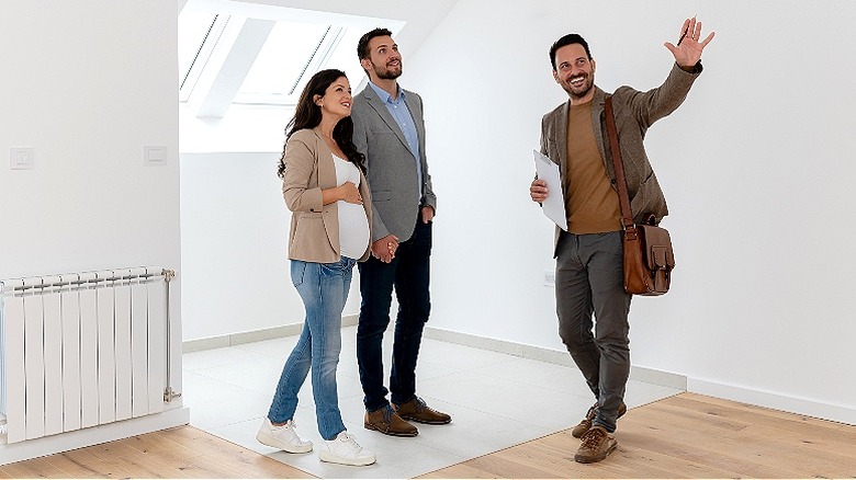 Young couple being shown house